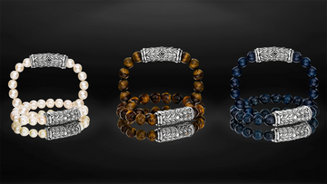 Luxury interchangeable clasp bracelets in pearl, tiger’s eye, and blue sapphire beads on reflective black background – handcrafted by Daneila Léon.