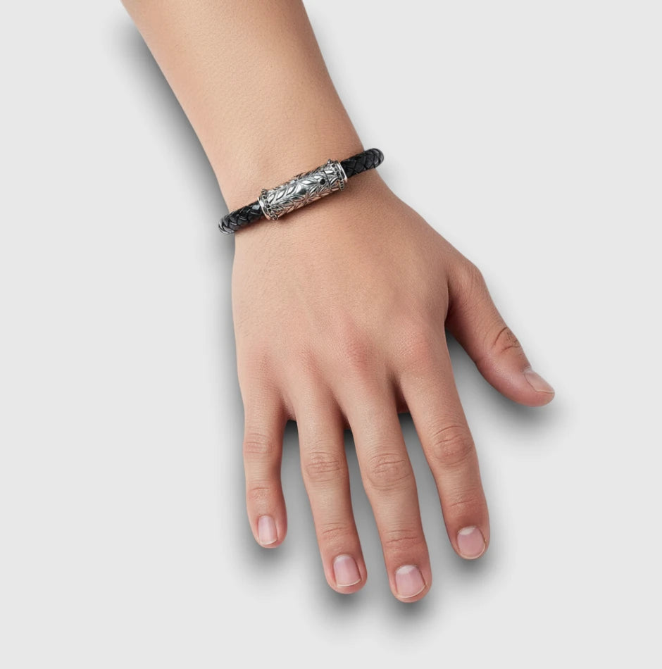 Sterling silver engraved clasp bracelet with black braided leather & black diamonds, shown worn on the wrist for scale and fit.