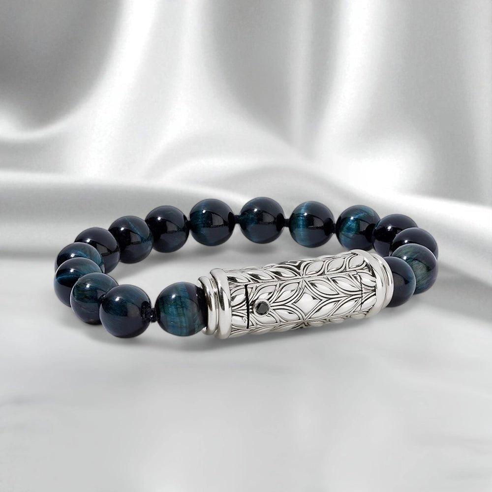Blue Tiger Eye interchangeable bracelet with sculpted Persian Shield silver clasp and diamond accents, styled on white satin with tagline “Layer, Switch, and Define Your Style. Your Bracelet. Your Expression.”