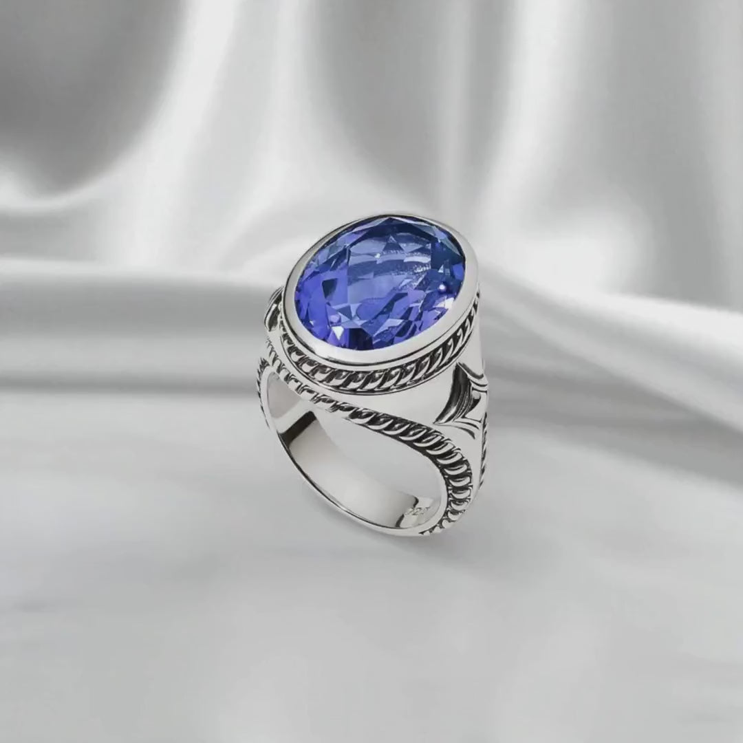 Persian Shield lab-grown blue sapphire silver ring, 4.5 carats, showcased in a rotating close-up. Handcrafted sterling silver band with intricate detailing, highlighting the ideal-cut sapphire’s brilliance and elegant unisex design."