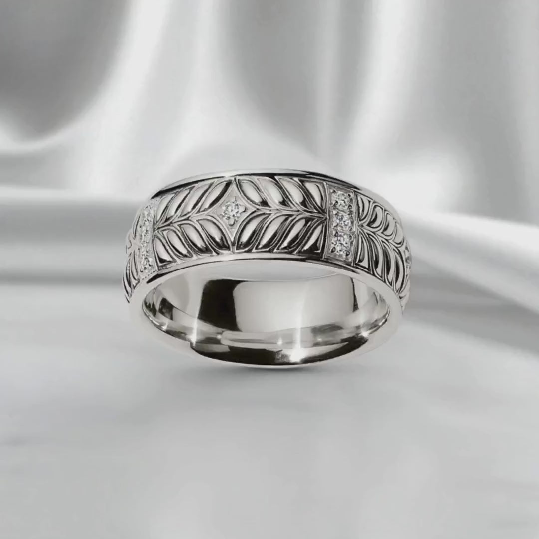 Sterling silver band with Persian Shield leaf motif and diamond accents, crafted with sculptural detail on a satin backdrop