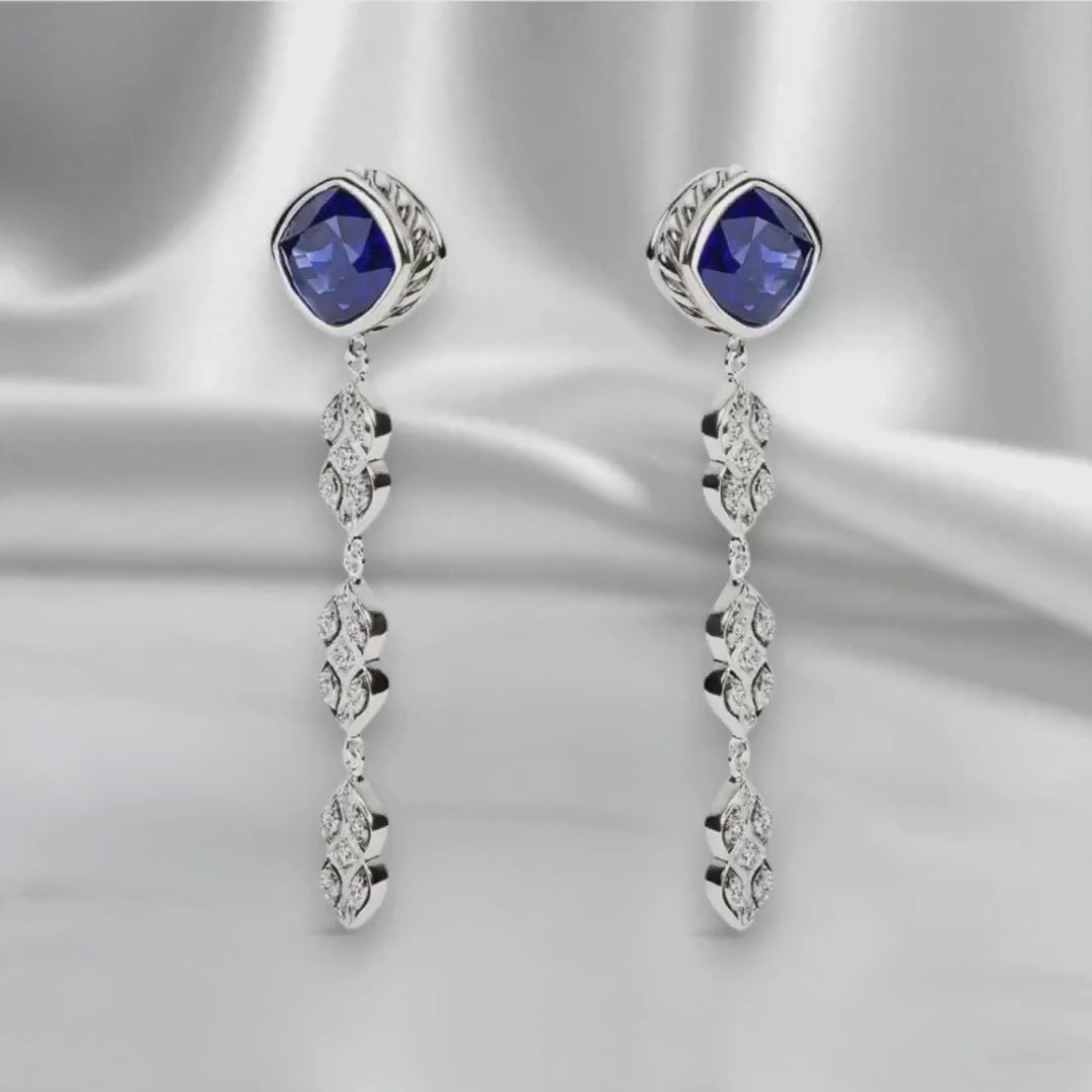 Sterling silver chandelier earrings with precision ideal-cut lab sapphires, rotating to highlight light reflection and craftsmanship.